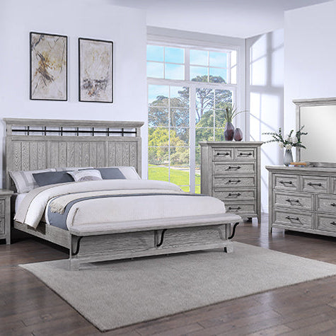 Gray bedroom furniture set with bed, nightstands, dresser, and mirror in a bright room.
