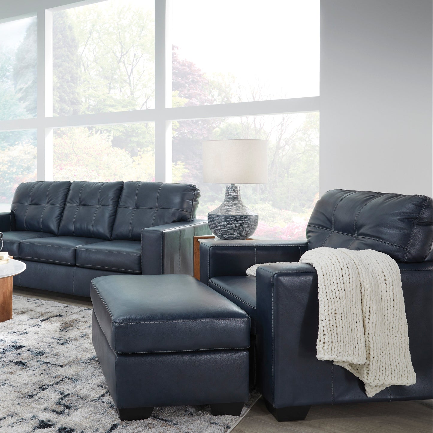 Modern living room with dark gray leather sectional sofa set.