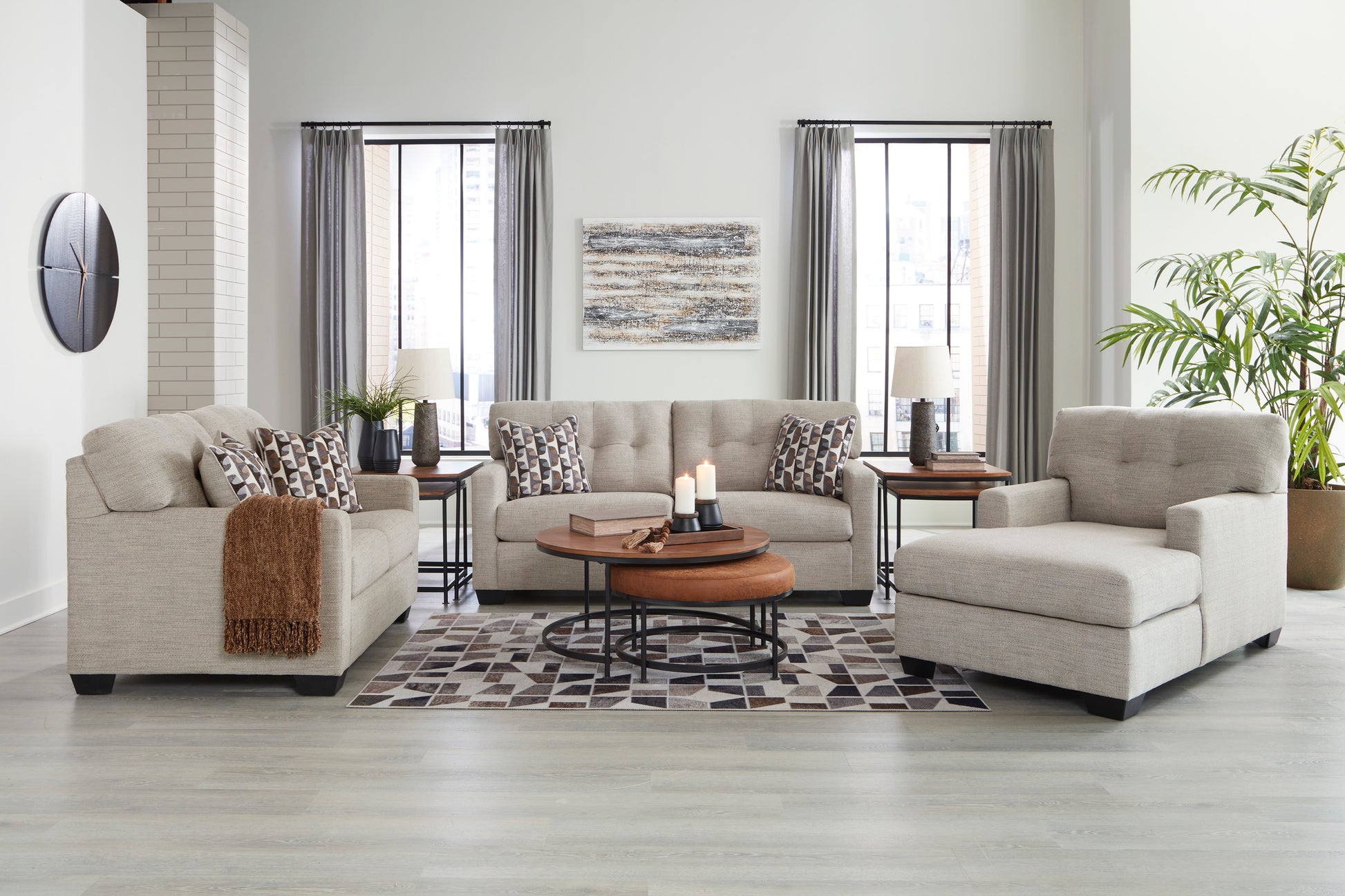 Living room with beige sofa, armchair, and coffee table on a checkered rug.