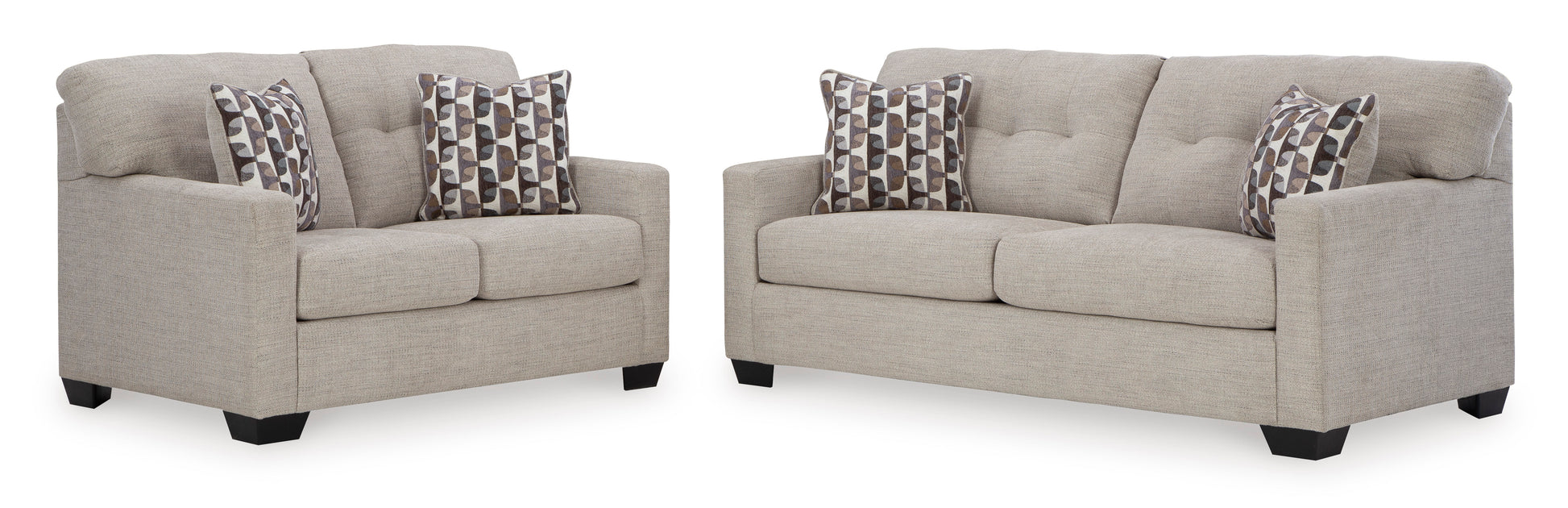 Two beige sofas with patterned cushions on a white background