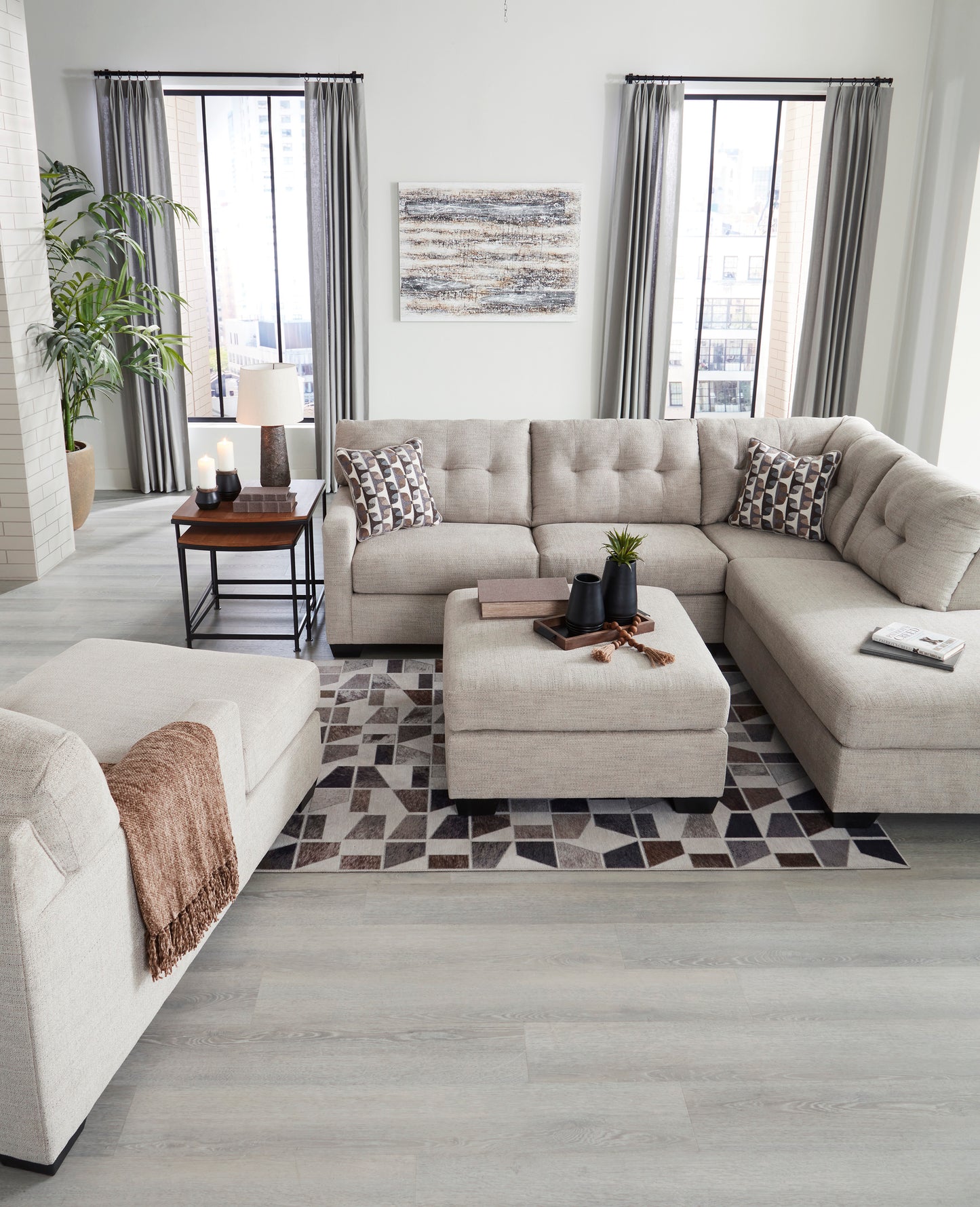 Modern living room with a beige sectional sofa, coffee table, and decorative elements.