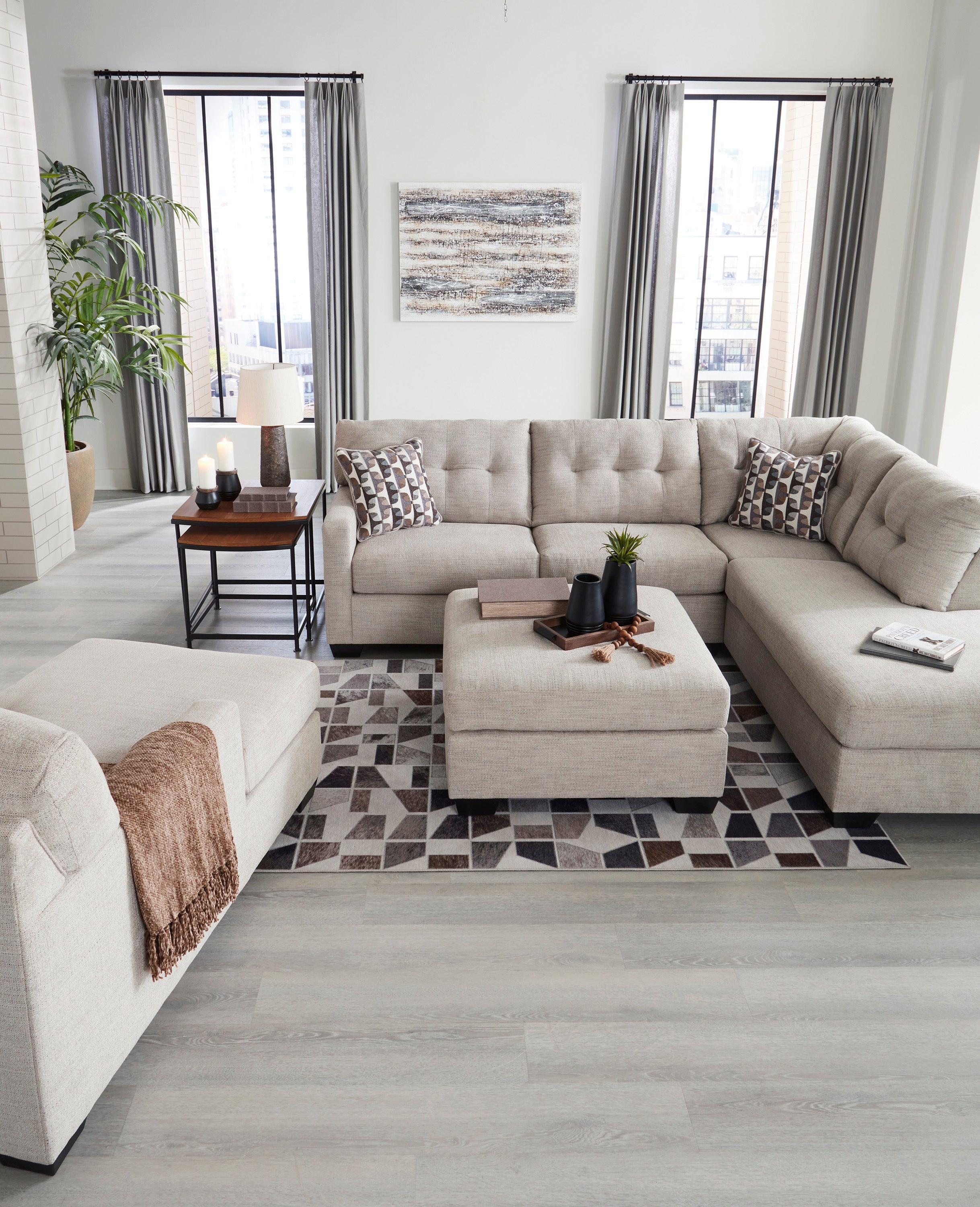 Modern living room with a beige sectional sofa, coffee table, and decorative elements.