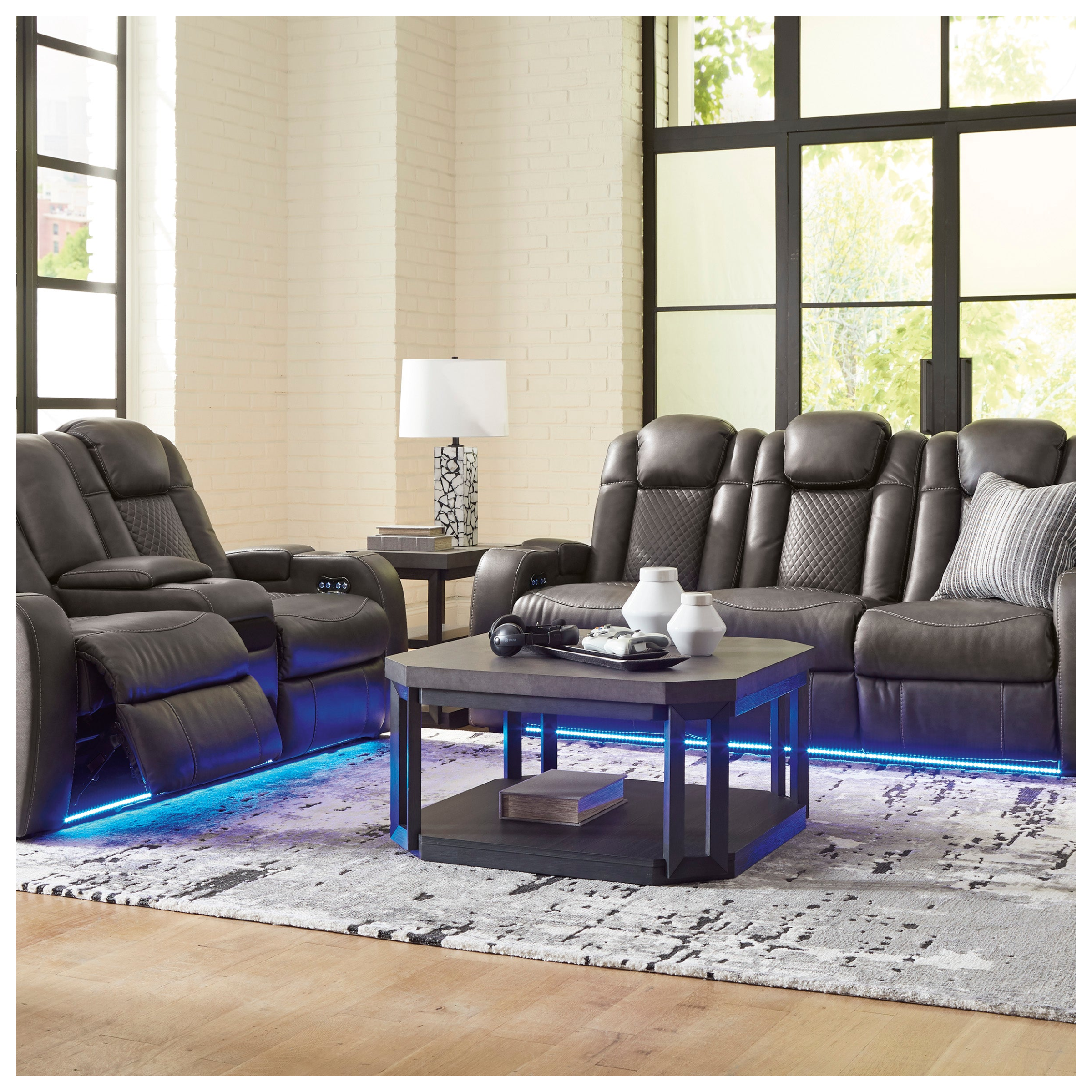 Modern living room with gray leather recliner chairs and a coffee table.