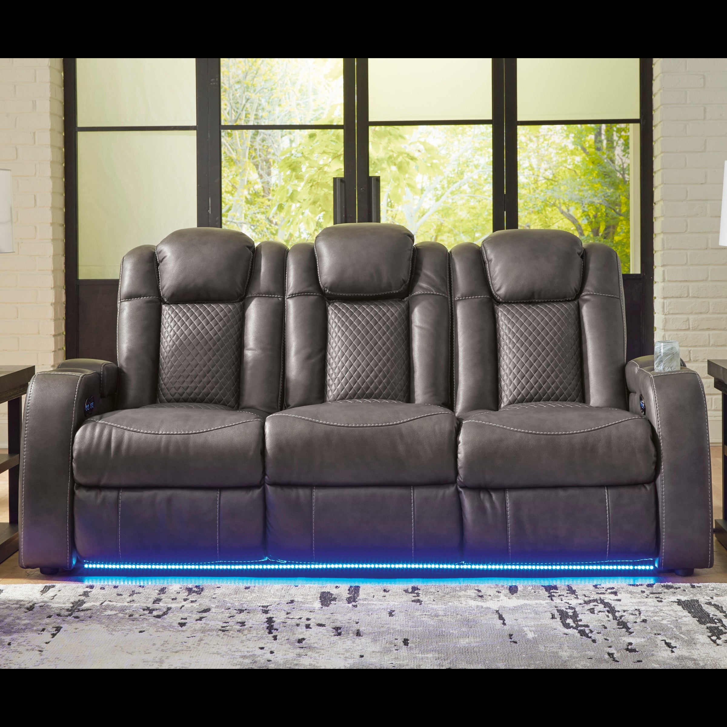 Gray reclining sofa with LED lighting in a living room setting