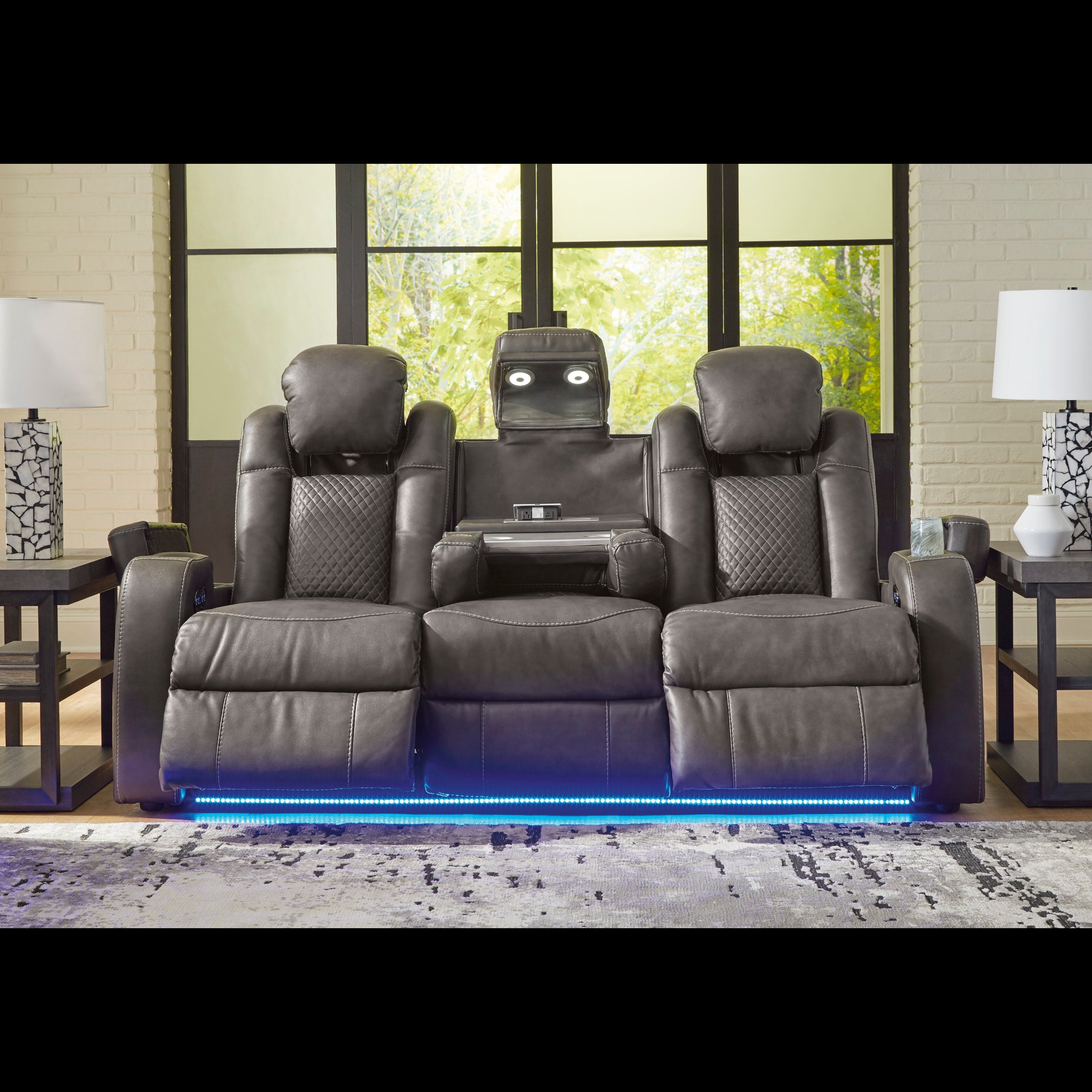 Gray recliner seats with LED lighting in a room with large windows.