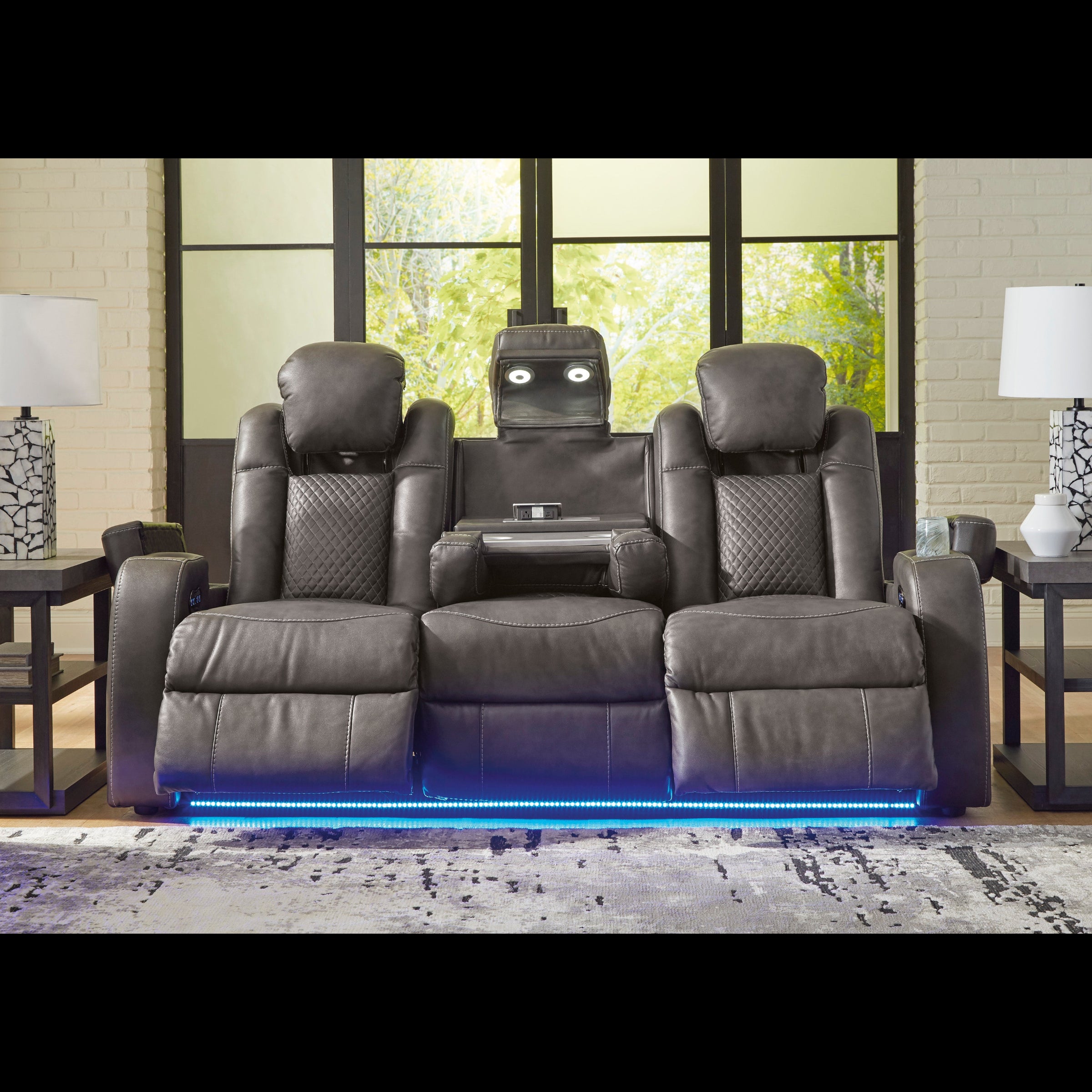 Gray recliner seats with LED lighting in a room with large windows.