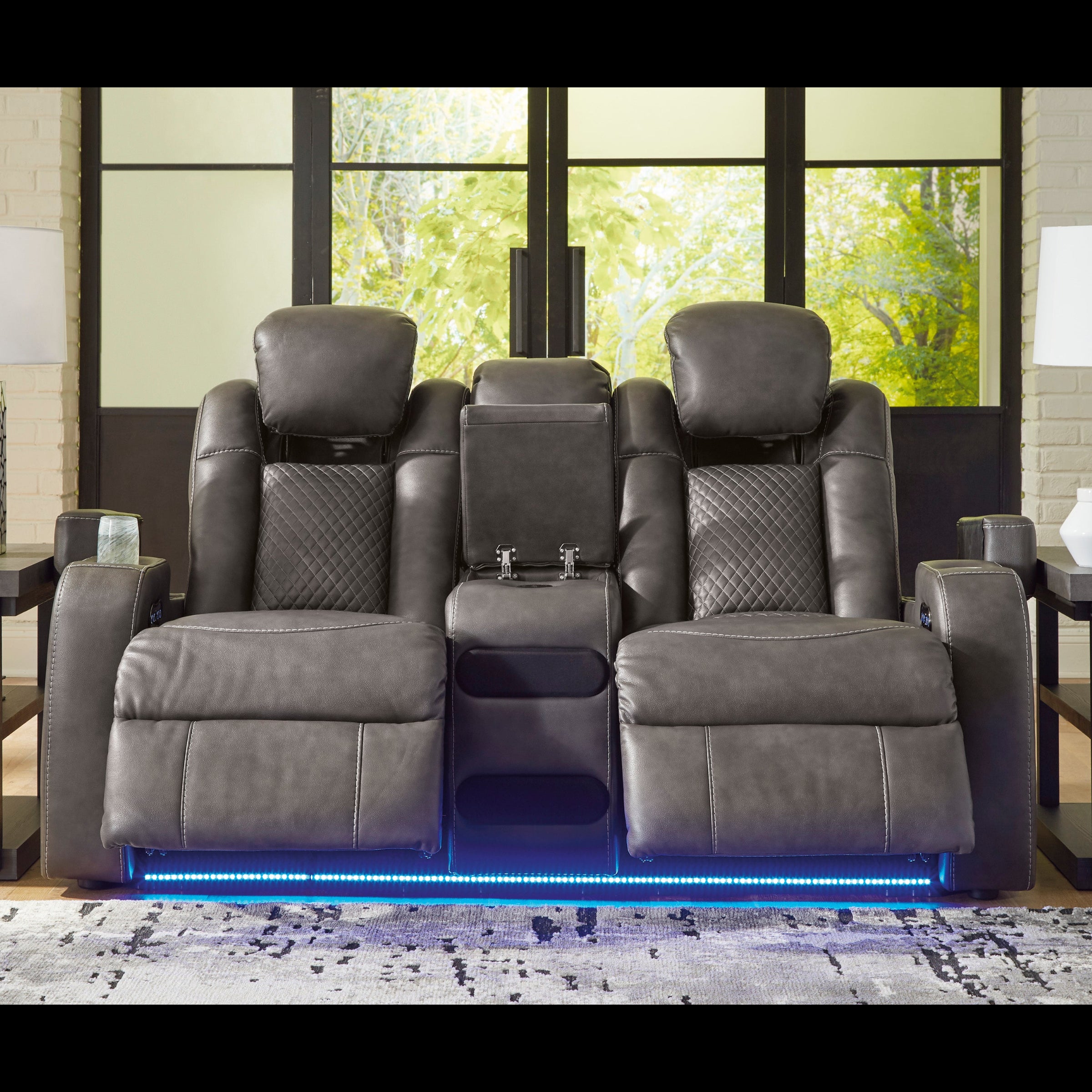 Gray recliner chairs with LED lighting in a room with large windows.