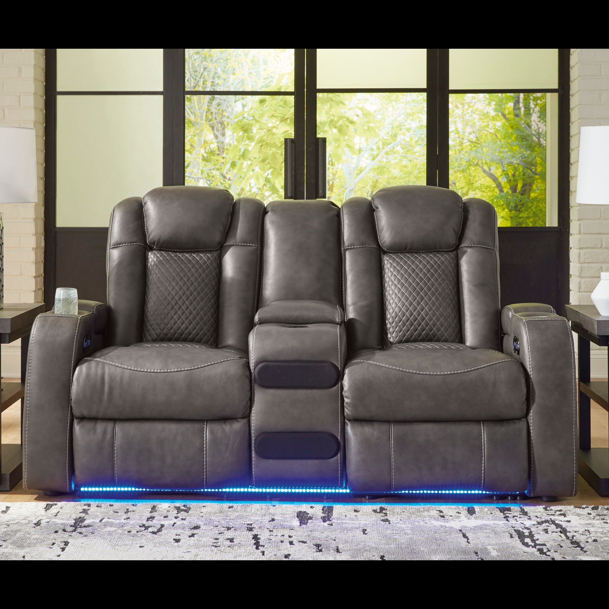 Gray recliner chairs with LED lighting in a room with large windows and lamps.