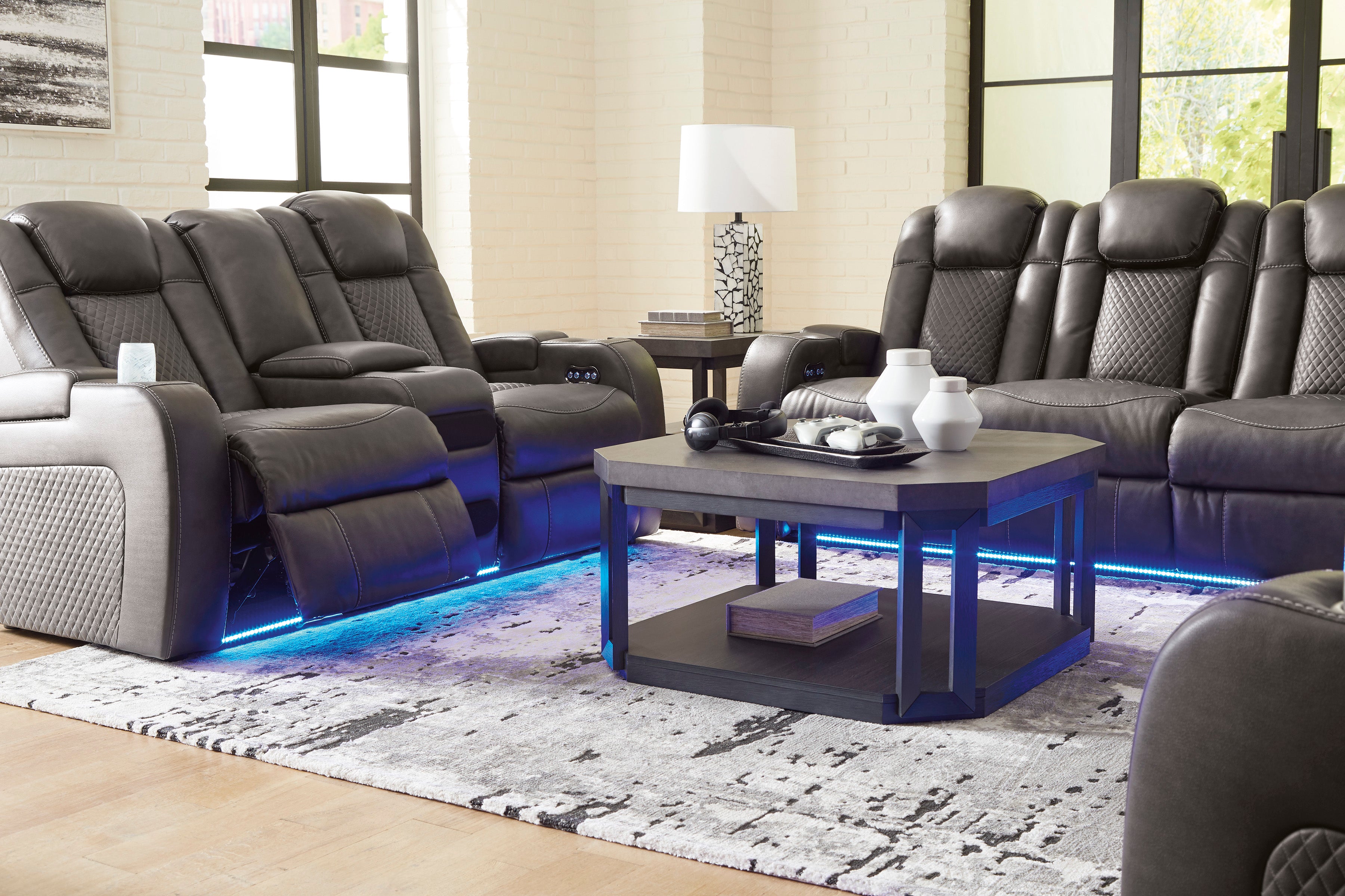 Modern living room with gray recliner chairs and a coffee table.