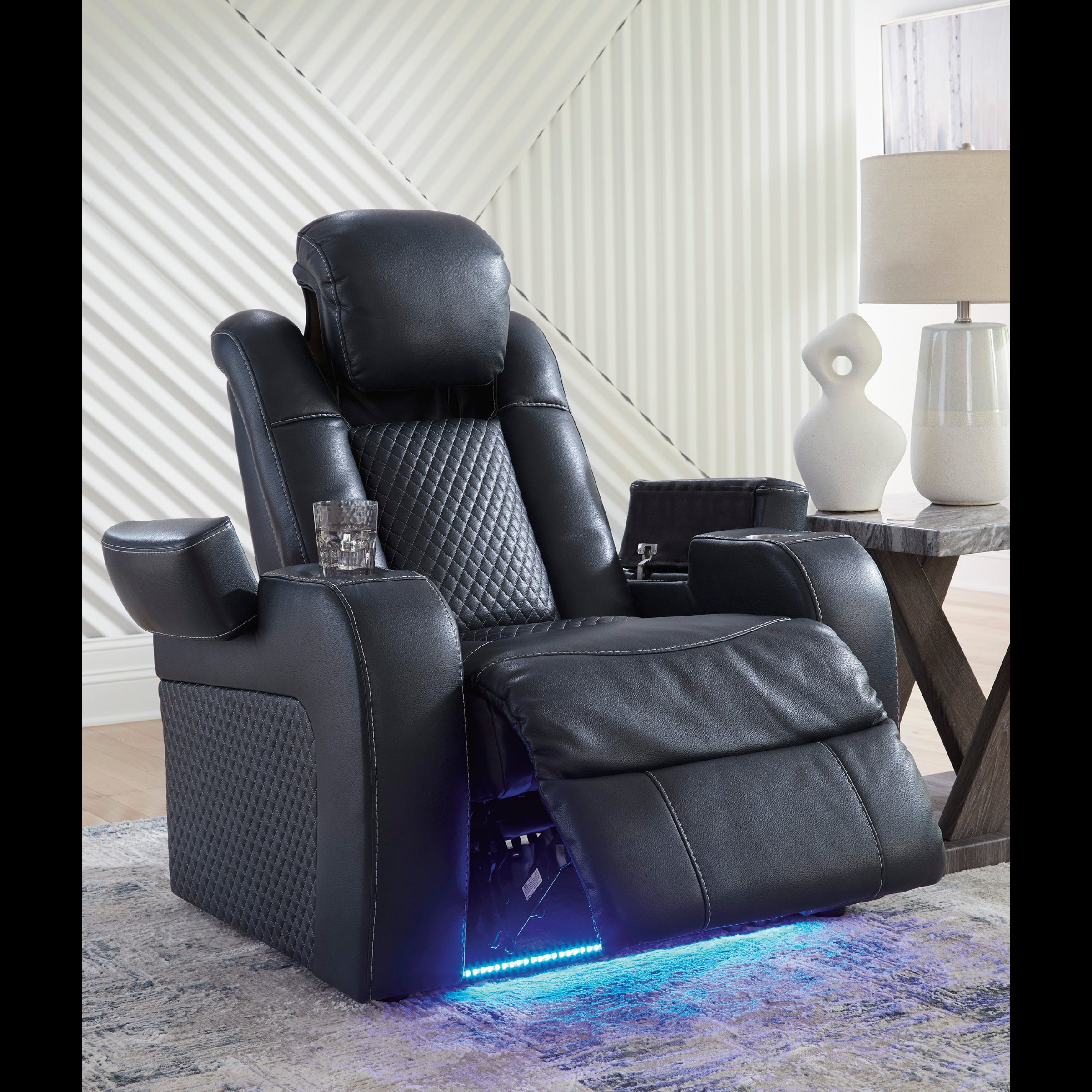 Black leather recliner chair with LED lighting in a room setting.