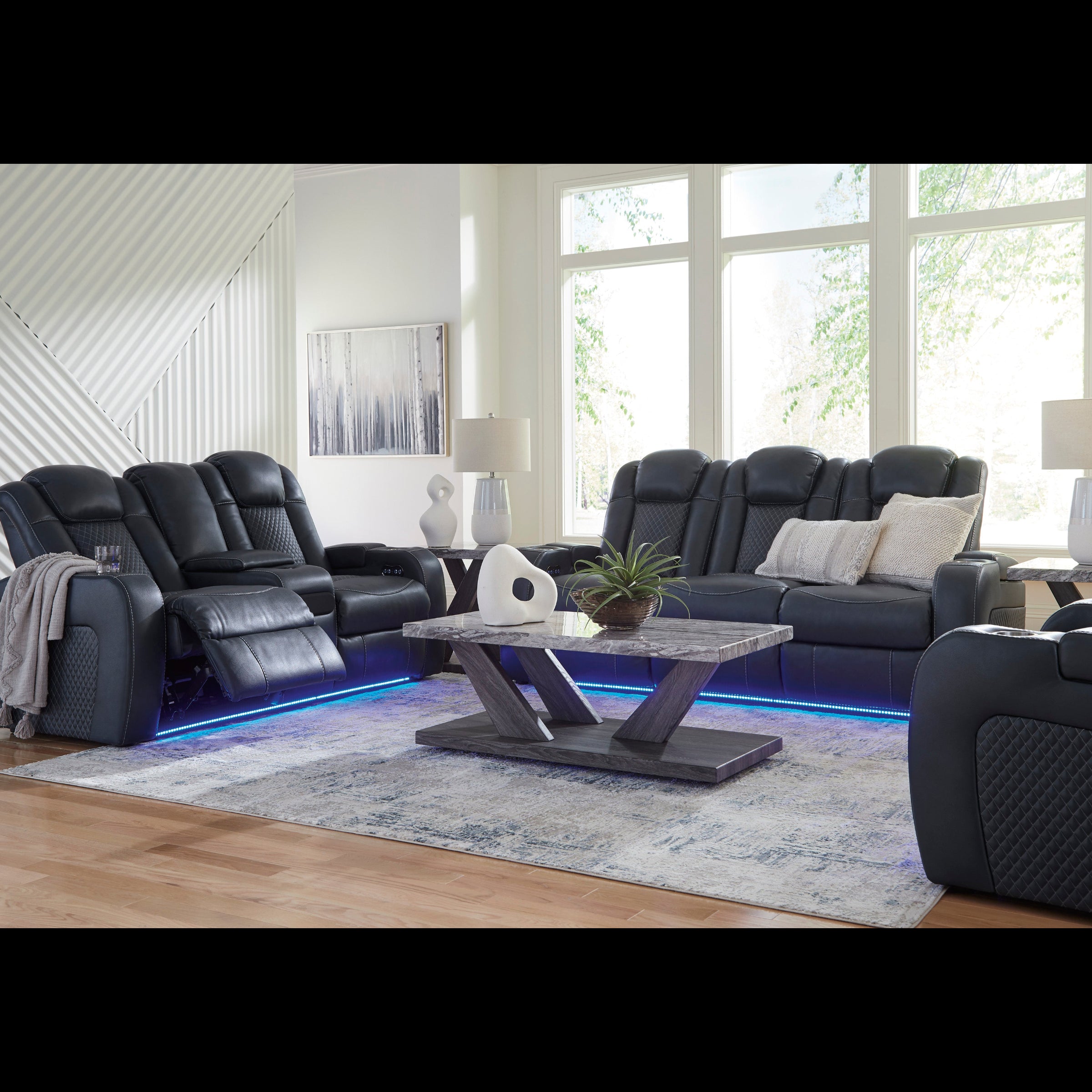 Modern living room with black leather recliner chairs and a coffee table.