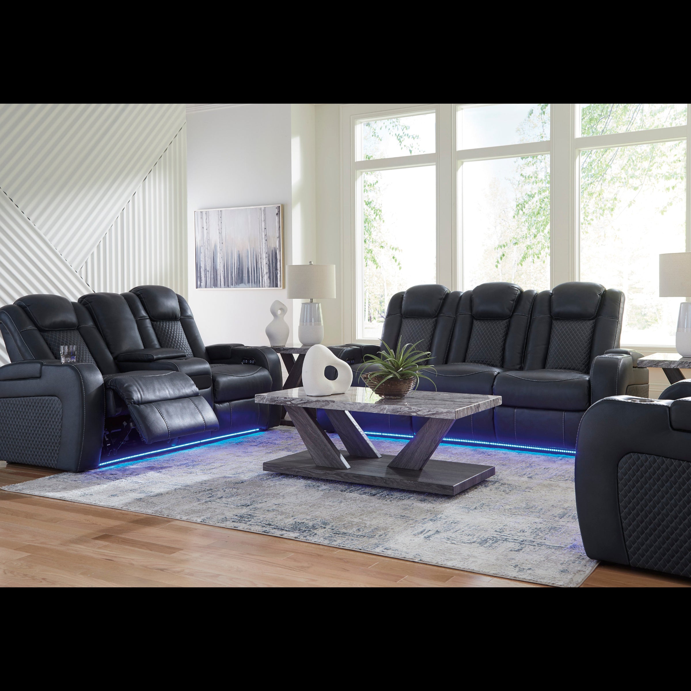 Modern living room with black leather recliner chairs and a coffee table.