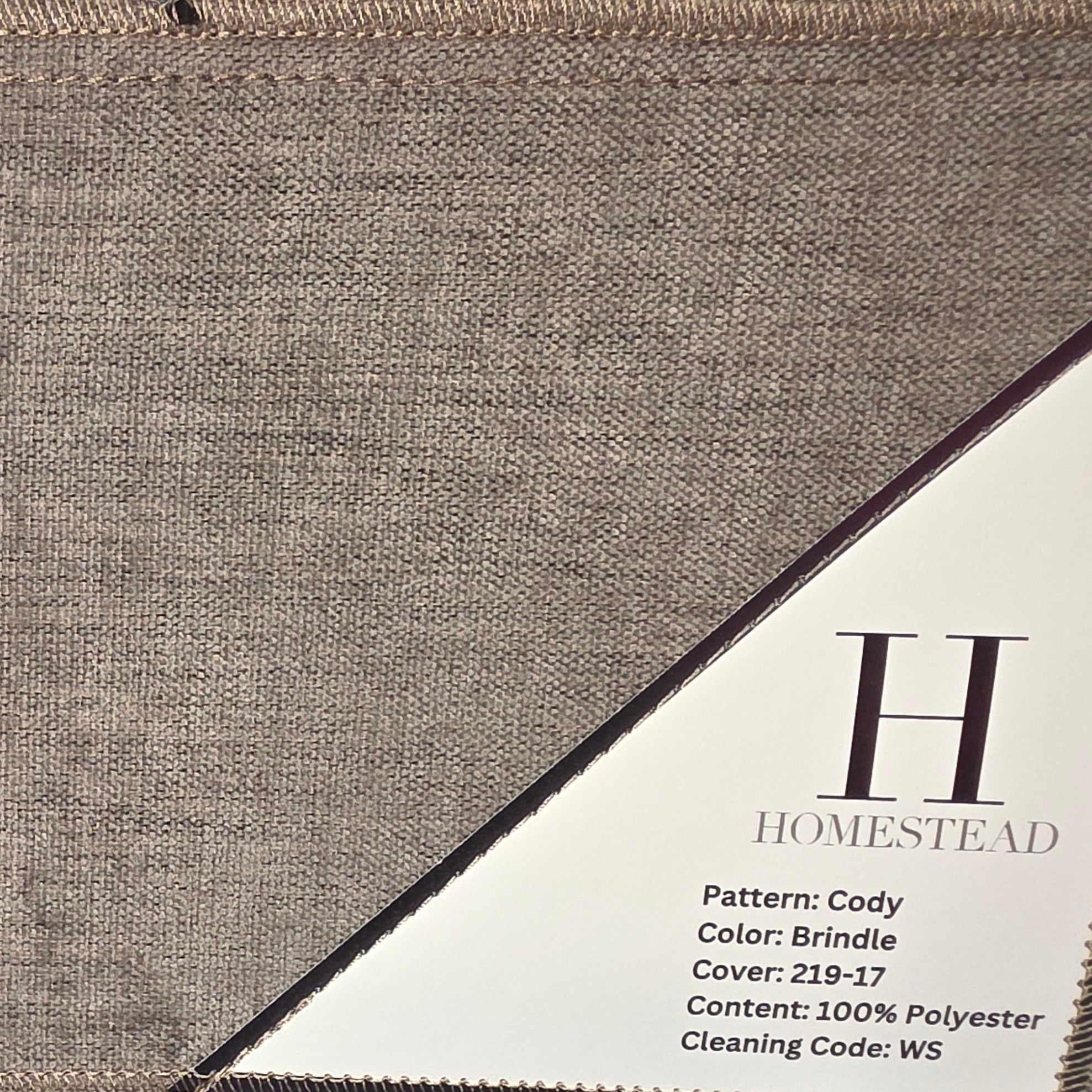 Two rectangular fabric samples from Homestead Polyester, pattern Cody, displayed side by side. The top sample is in a warm taupe-brown color (Brindle) and the bottom sample is in a slate gray color (Dusk).