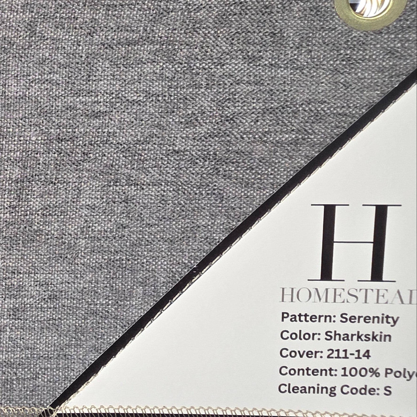 A fabric swatch display showing a gray woven textile labeled 'Homestead' with pattern 'Serenity' and color 'Sharkskin,' alongside a beige version labeled 'Homestead' with pattern 'Serenity' and color 'Peyote.'.