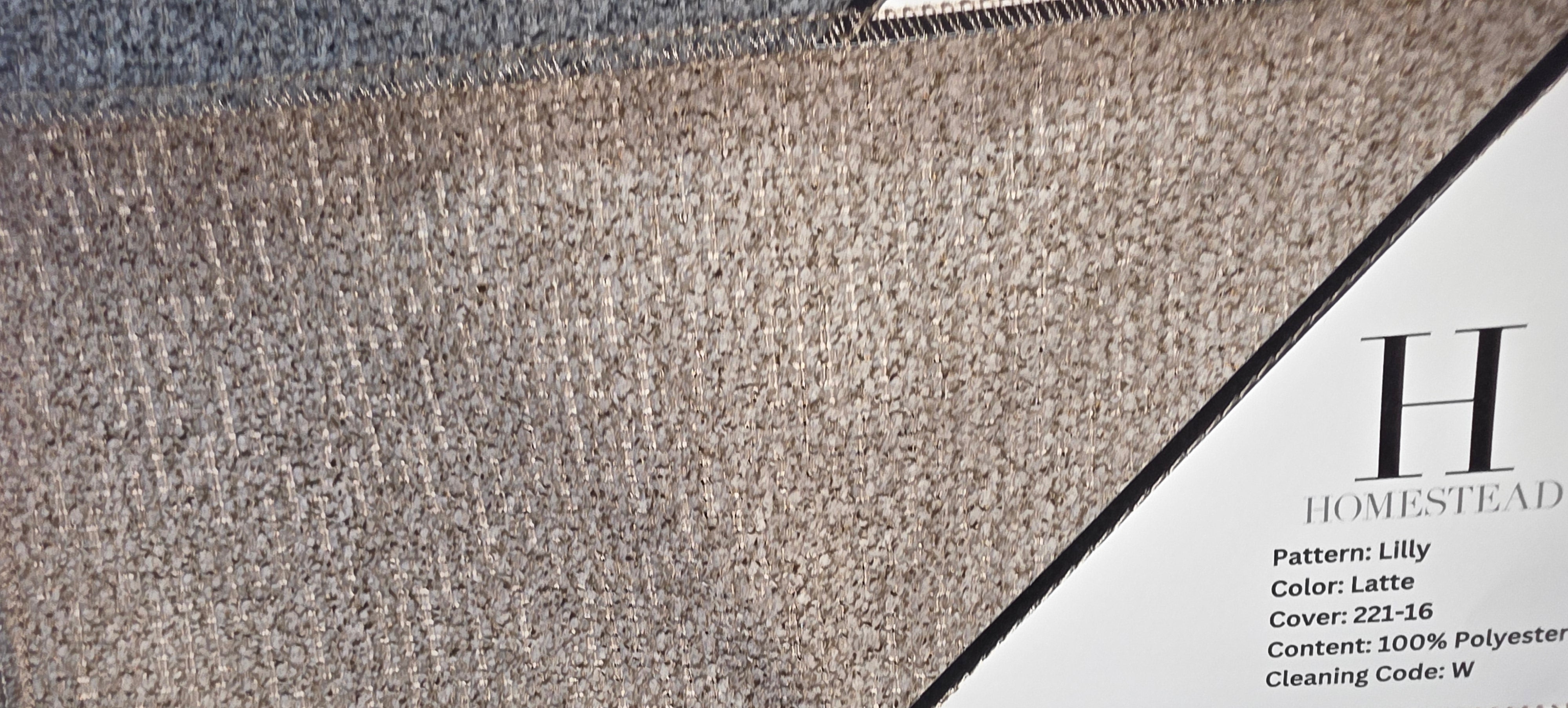 Two carpet or fabric swatch samples displayed side by side, with printed labels reading Homestead and Pattern: Lilly, Color: Lattice. The top sample is a warm taupe/beige heathered texture, and the bottom sample is a darker brown textured weave.