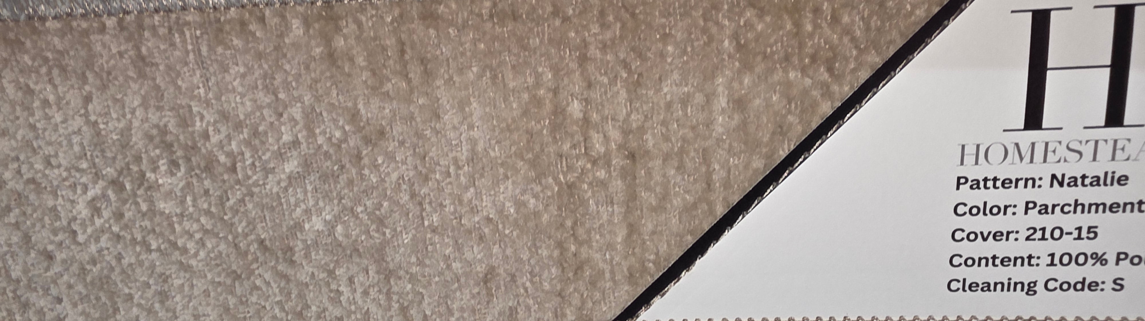 Three fabric swatches from Homestead Homestead, including a gray textured fabric, a beige textured fabric, and a taupe-brown textured fabric, with printed product information cards visible.
