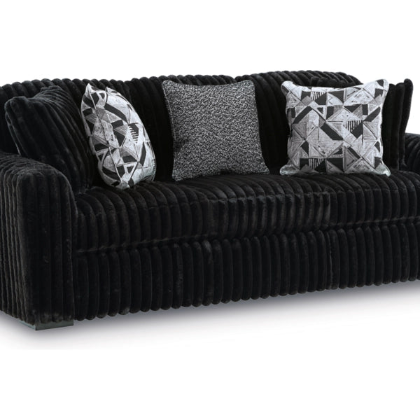 Black ribbed sofa with patterned cushions on a white background