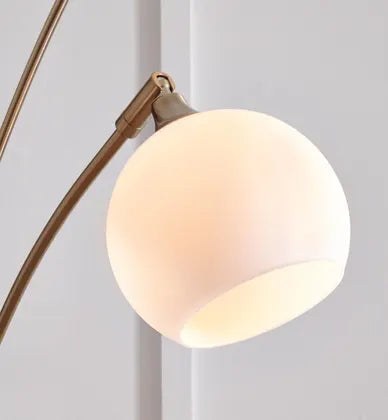 Modern floor lamp with multiple lights in a living room setting. Taliya Metal Arc Lamp hillsmattressmore.com