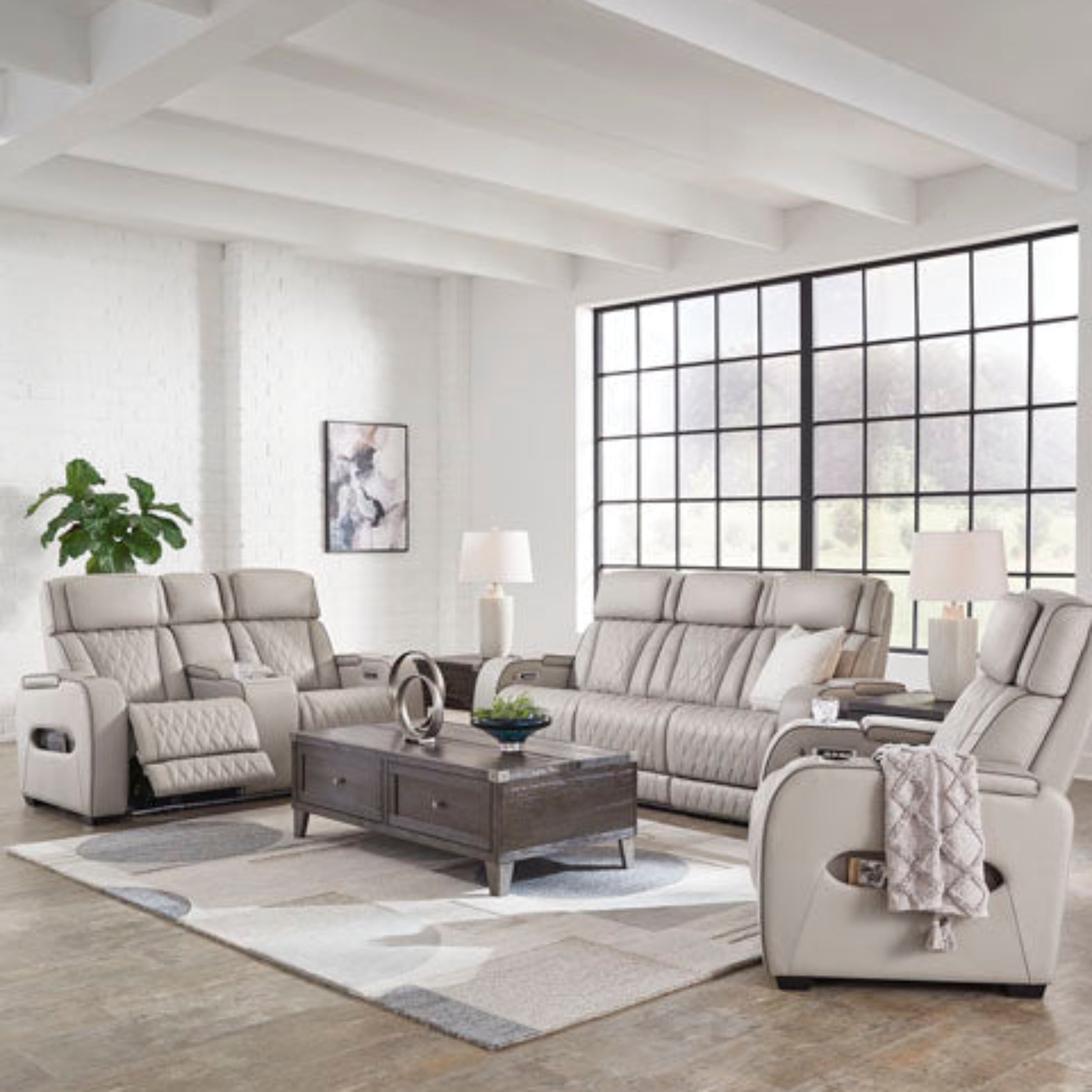 Modern living room with gray sectional sofa and recliners.