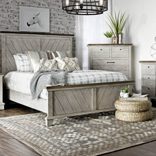 Neatly arranged bedroom with wooden furniture, including a bed and dressers.