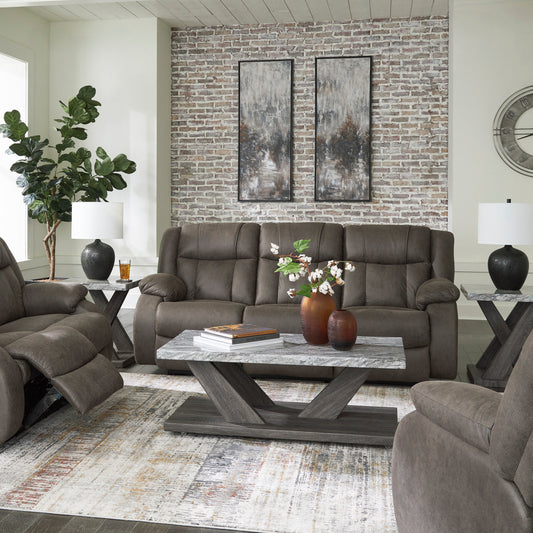 Gray reclining sofa set in a living room with decorative elements.
