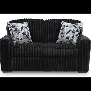 Black sofa with patterned cushions on a white background