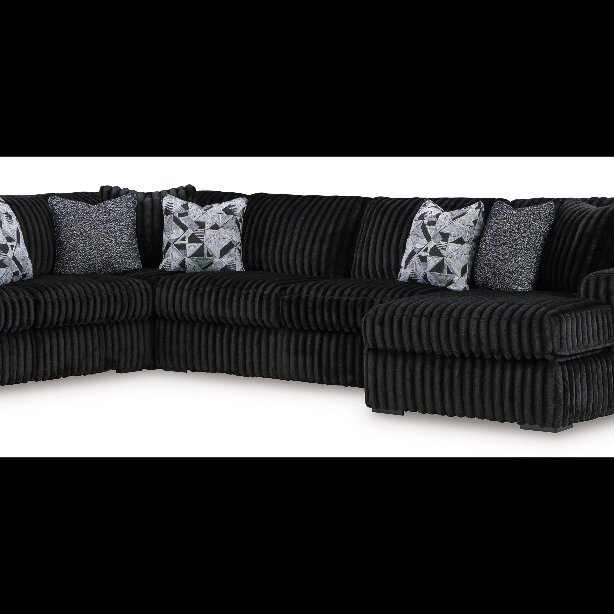 Black sectional sofa with patterned cushions on a white background